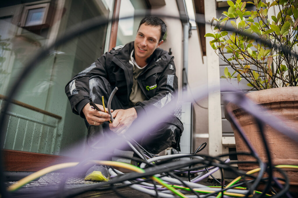 Gruene-Leuchte_Grossanlagen-PV-Photovoltaik-AC-Montage-Elektrik-Mitarbeiter-Strom-Anschluss-Kabel